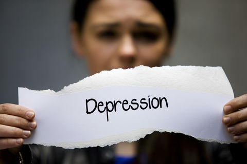 Girl holding 'depression' sign